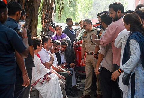 Lok Sabha LoP Rahul Gandhi interacts with police personnel at Akashvani Bhawan during the INDIA bloc-led protest march from Parliament House to Nirvachan Sadan, demanding Chief Election Commissioner Gyanesh Kumar's resignation over the alleged irregularities in the electoral roll, in New Delhi on Tuesday.