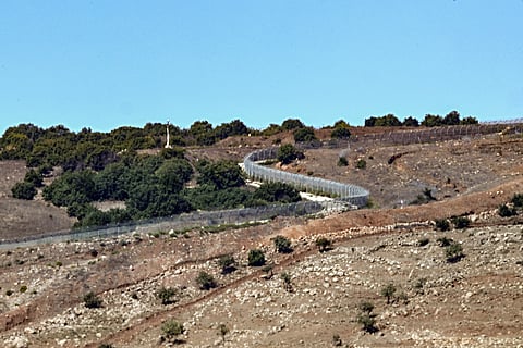 A barbed-wire fence separating Syrian and Israeli-controlled areas is pictured near the village of Jbata al-Khashab in Quneitra in southwestern Syria near the Israeli-annexed Golan Heights on October 7, 2026