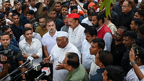 Congress President Mallikarjun Kharge speaks to the media as party leader Rahul Gandhi, TMC leader Abhishek Banerjee and others look on after a lunch hosted by the party President for INDIA bloc leaders, for the second consecutive day, at Moets restaurant, Connaught Place, in New Delhi, Thursday, Oct. 8, 2026.