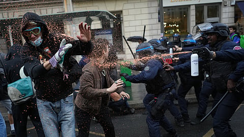 Police officers spray students with pepper spray near Sciences Po University as they protest against under-resourced schools in Paris, Wednesday, Oct. 7, 2026.