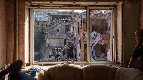 Locals and rescuers clear the rubble of a residential building destroyed in a Russian missile strike on Pryluky, Ukraine, Wednesday, Oct. 7, 2026.