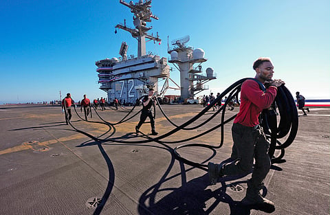 Crew members prepare the U.S.S. Abraham Lincoln (CVN 72) for return on Wednesday, Oct. 7, 2026, to her home port Naval Air Station North Island in San Diego, Calif.