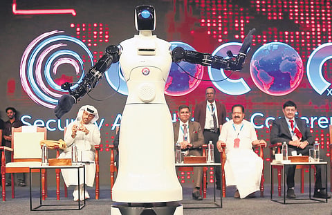 Home Minister Ramesh Chennithala watching the demonstration of a humanoid robot during the inaugural ceremony of c0c0n 2026 cyber security and hacking conference at Grand Hyatt in Kochi on Friday | pics: t P Sooraj