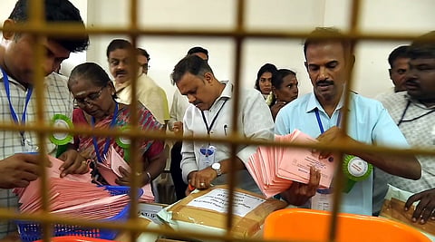 Tiruppur: Polling officials at work during the counting of votes for the Dharapuram Assembly by-election, in Tiruppur district, Tamil Nadu, Friday, Oct. 9, 2026.