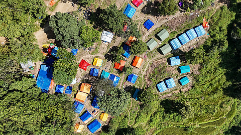 This photograph taken on October 1, 2026 shows an aerial view of temporary shelter tents uphill in Betrawati in Nepal's Nuwakot district in the aftermath of the August 26 flash flood.