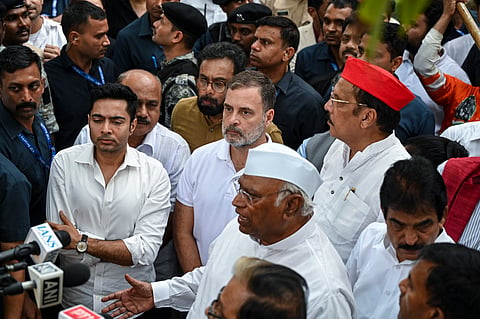 Congress President Mallikarjun Kharge speaks to the media as party leader Rahul Gandhi, TMC leader Abhishek Banerjee and others look on after a lunch hosted by the party President for INDIA bloc leaders, for the second consecutive day, at Moets restaurant, Connaught Place, in New Delhi, Thursday, Oct. 8, 2026.