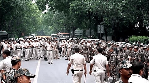 Security personnel keep vigil as heavy police deployment and entry restrictions are enforced ahead of a planned protest by Cockroach Janta Party (CJP) members, in New Delhi, Saturday, Oct. 10, 2026.