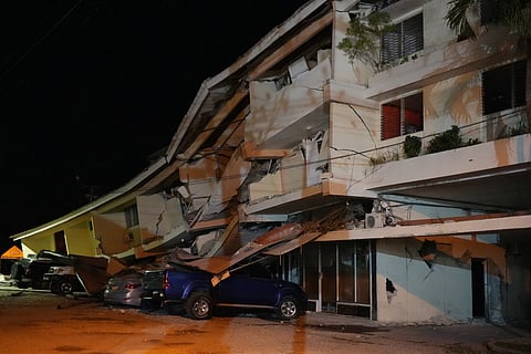 Vehicles lie crushed beneath a collapsed hotel after an earthquake struck Penonome, Panama, Friday, Oct. 9, 2026.