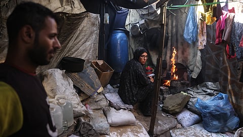 In this photo taken on October 6, 2026, Morsi and Nihaya Al-Masri, a displaced Palestinian couple from Beit Hanoun, are seen at their makeshift shelter in Khan Yunis, in the southern Gaza Strip.