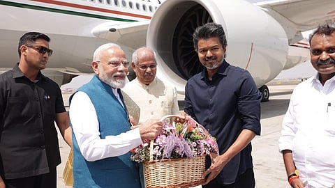 Chief Minister C Joseph Vijay (L) receives PM Modi at Chennai airport.