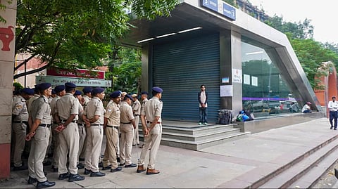 Security personnel stand guard near Janpath Metro Station ahead of protest.