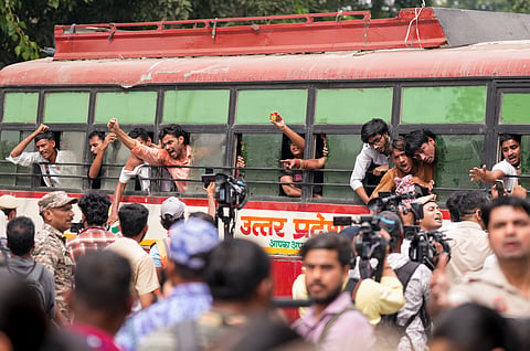 Detained protestors raise slogans amid continued demonstration calls by the Cockroach Janta Party (CJP) demanding the resignation of Chief Election Commissioner (CEC) Gyanesh Kumar, in New Delhi, Sunday, Oct. 11, 2026.