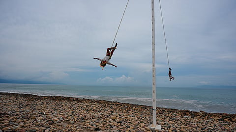 The Flying Men of Papantla perform the "Danza de los Voladores" on the beach as Hurricane Simon approaches Puerto Vallarta, Mexico, Saturday, Oct. 10, 2026.