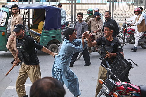 Police officers detain a supporters of imprisoned former Prime Minister Imran Khan's party during a protest against the Pakistani president declared a state of emergency in northwestern Khyber Pakhtunkhwa province and suspended its government, in Peshawar, Pakistan, Monday, Oct. 12, 2026.
