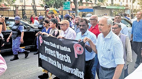 Media professionals hold a silent march near the Press Club of India on Tuesday