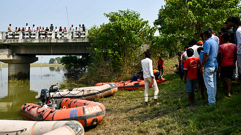 Rescue operation underway to trace any missing occupants of a boat that capsized in the Ganga River a day ago, resulting in the death of at least 13 children, at Hajipur, in Bihar's Vaishali district, Wednesday, Oct. 14, 2026