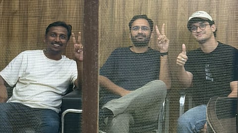 Cockroach Janta Party (CJP) leaders Saurav Das (R), Ashutosh Ranka (C) and Ajinkya Shinde (L) detained inside the parliament street police station in New Delhi on Wednesday, Oct. 14, 2026.