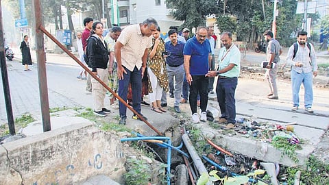 Chief Commissioner M Maheshwar Rao inspects an open drain that poses a risk to pedestrians on Bannerghatta Main Road on Tuesday.
