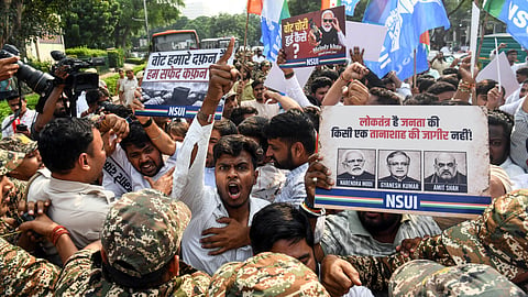 NSUI workers raise slogans during a protest against Chief Election Commissioner Gyanesh Kumar at Connaught Place in New Delhi on Tuesday.