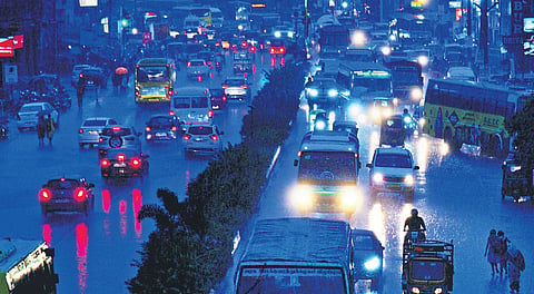 Motorists driving through rain on Poonamallee High Road in Chennai on Wednesday. Meenambakkam recorded 5.2 mm of rainfall.