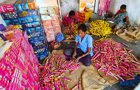 Workers assembling crackers at a fireworks unit near Aruppukottai
