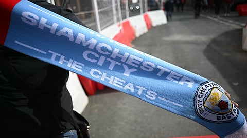 Merchandise mocking Manchester City and their financial scandal are seen for sale ahead of the English Premier League football match between Liverpool and Manchester City at Anfield in Liverpool, north west England on October 11, 2026.