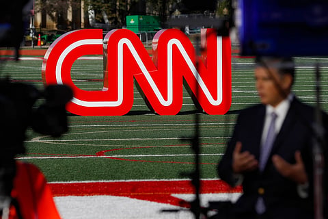 A journalist records video near a CNN sign on an athletic field outside the Clements Recreation Center where the CNN/New York Times will host the Democratic presidential primary debate at Otterbein University, Monday, Oct. 14, 2019, in Westerville, Ohio.