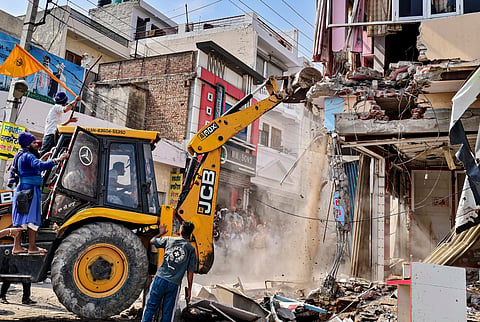 District authorities demolish a portion of the house belonging to Ashwani Kumar, the medical store owner who fatally shot anti-drug activist Parvinder Singh Jhota on Wednesday