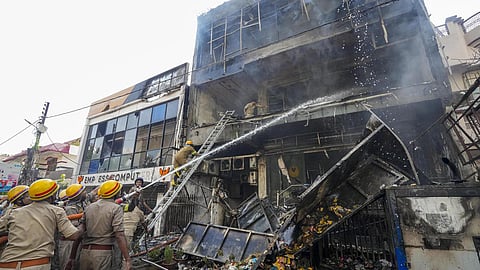 fire personnel conucting a dousing operation at a comercial building in Bhubaneswar