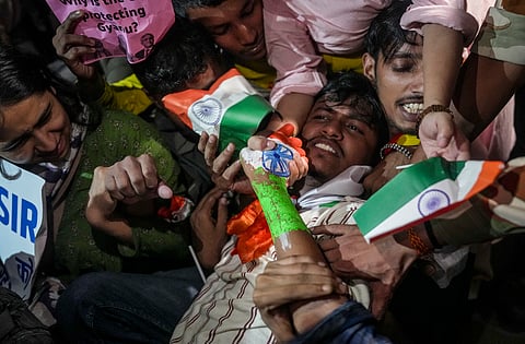 Protesters being removed by the police during 'Lehra Do Tiranga' protest called by the Cockroach Janta Party (CJP) demanding the resignation of Chief Election Commissioner (CEC) Gyanesh Kumar over alleged irregularities in the Special Intensive Revision (SIR) of electoral rolls, at Connaught Place, in New Delhi, Friday.