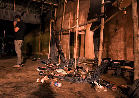 Footwear lies scattered outside a Durga Puja pandal after the exit gate collapsed due to heavy crowd pressure, leading to a stampede-like situation, in Kolkata, Saturday, Oct. 17, 2026.