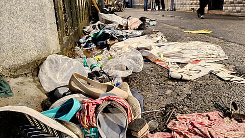 Footwear lies scattered outside a Durga Puja pandal after the exit gate collapsed due to heavy crowd pressure, leading to a stampede-like situation, in Kolkata, Saturday, Oct. 17, 2026.