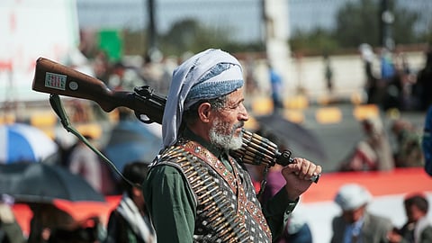 A supporter of Yemen's Houthi rebels carries his rifle during a rally in support of the group in Sanaa, Yemen, Friday, Oct. 9, 2026.