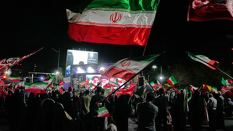 Demonstrators wave Iranian flags during a pro-government gathering at a square in Tehran, Thursday, Oct. 8, 2026.