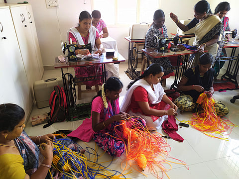 Women undergo vocational training in tailoring and thread basket-making at a community centre run by Prema’s organisation.