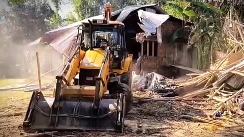 In this file image from Nov 30, 2025, an eviction drive is being carried out at the Lutumari Reserve Forest in Assam.