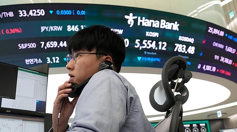 A currency trader talks on the phone at the foreign exchange dealing room of the Hana Bank headquarters in Seoul, South Korea, Monday, Oct. 19, 2026.