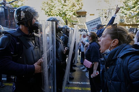 A woman shouts at riot police during an anti-government protest in Tirana, Albania, Tuesday, Oct. 20, 2026.