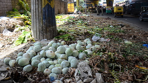 Left over puja materials and uncleared garbage at city market in Bengaluru on Wednesday.