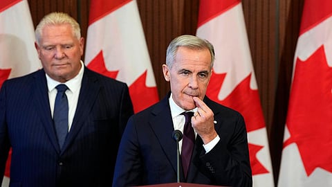 Canadian Prime Minister Mark Carney listens to a question as he and Ontario Premier Doug Ford participate in a joint news conference on Parliament Hill in Ottawa, on Wednesday, Oct. 21, 2026.