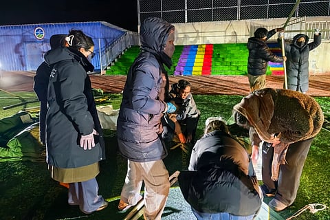 In this photo released by Xinhua News Agency, people set up tents for quake-affected residents at a primary school following an earthquake hit in Baqen County of Nagqu City in southwest Tibet autonomous region on Friday, Oct. 23, 2026.