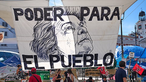 A banner depicting Maria del Carmen Abascal, the 87-year-old woman whose eviction sparked nationwide protests, hangs in Puerta del Sol square in Madrid, Spain, Friday, Oct. 16, 2026.