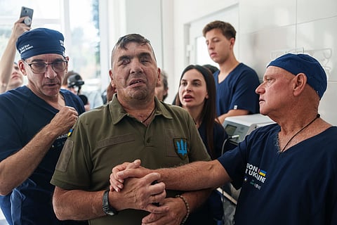 Stuart Seiff, a U.S. oculoplastic surgeon, right, speaks to wounded soldier Mykola Kasiuk, after surgery at a hospital in Kyiv, Ukraine, Tuesday, Sept. 29, 2026