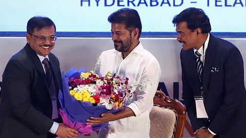 Karnataka DGP MA Saleem gives a bouquet to Telangana Chief Minister A Revanth Reddy during the Southern region police coordination conference (SRPCC) at ICCC in Hyderabad on Friday.