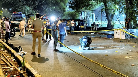 Police and forensic officials conduct investigation at the crime scene where gunmen opened fire at Bollywood actor Tiger Shroff, near Pushpa Park under Juhu police station, in Mumbai, Maharashtra, Sunday, Oct. 18, 2026.