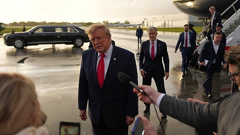 President Donald Trump talks to reporters after arriving on Air Force One, Friday, Oct. 23, 2026, at President Donald J. Trump International Airport in West Palm Beach, Fla.