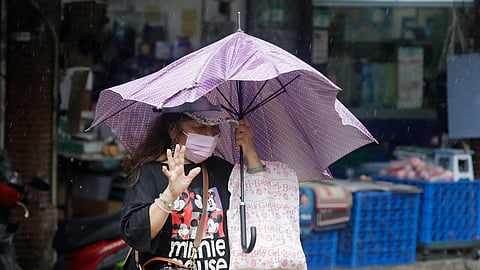 A woman struggles with winds generated by Typhoon Champi in Taipei, Taiwan, Friday, Oct. 23, 2026.