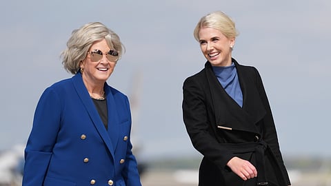 White House chief of staff Susie Wiles and White House aide Natalie Harp walk to board Air Force One, Friday, Oct. 16, 2026, at Joint Base Andrews, Md.
