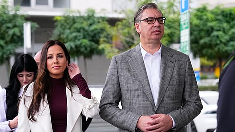 Aleksandar Vucic, leader of the right-wing Serbian Progressive Party (SNS), waits along with his wife Tamara to vote in a parliamentary election in Belgrade, Serbia, Sunday, Oct. 25, 2026.