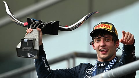 Race winner Mercedes' Italian driver Kimi Antonelli holds the trophy while celebrating on the podium at the conclusion of the United States Formula One Grand Prix at the Circuit of the Americas in Austin, Texas, on October 25, 2026.